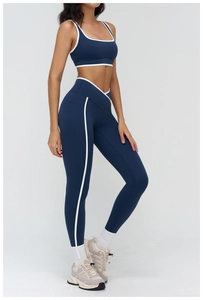 Detail of high-waisted yoga set with contrast piping and cross waistband design