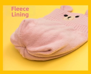 Detailed view of pink knitted hat showing thick fleece lining and cute bear design