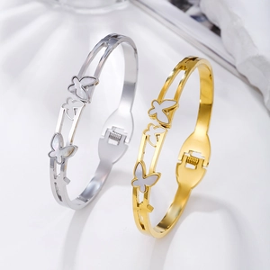Polished stainless steel butterfly bangle with shell inlay in gold and silver finish