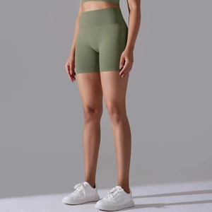 Detail of high-waisted seamless ribbed yoga shorts in olive green showing elastic fabric