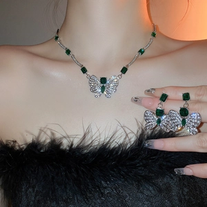Elegant butterfly jewelry set with green square gemstones and sparkling pave diamonds