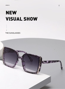 Detail of purple leopard frame sunglasses with gradient lenses on white geometric block