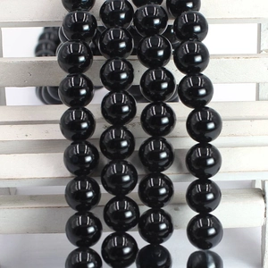 Detailed view of polished black agate round beads with glossy finish for DIY jewelry