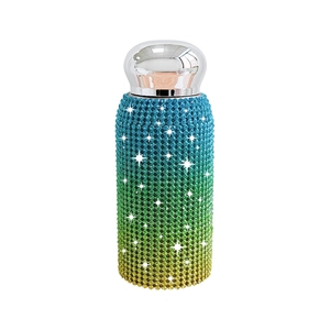 Sparkling rhinestone gradient vacuum insulated tumbler with silver metal lid on white background
