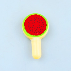 Macro detail of watermelon-shaped novelty lollipop pen with red pulp and black seeds