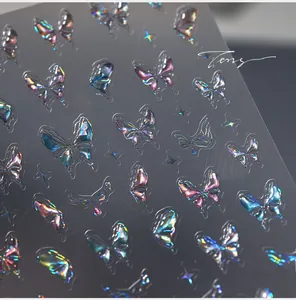 Macro shot of 3D embossed laser butterfly nail art stickers with iridescent star patterns