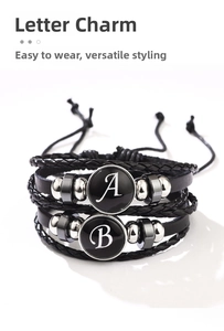 Detail view of black braided leather bracelet with adjustable cords and letter charms
