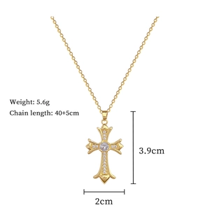 Detail view of gold cross pendant with dimensions 3.9cm by 2cm and chain length 40+5cm