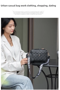 Close-up of black quilted crossbody bag with wide lettered strap and round coin purse
