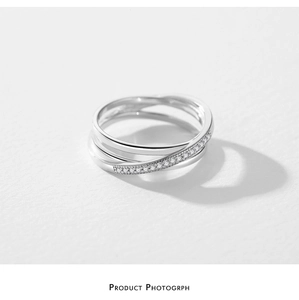 Detailed close-up of S925 sterling silver interlocking rings with micro-pave crystals