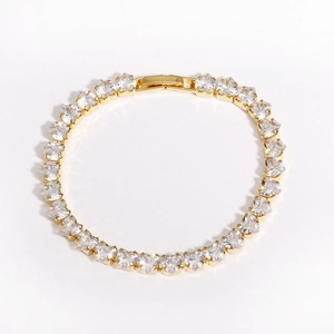 Detail shot of heart-shaped gold-plated bracelet with white cubic zirconia inlay gems