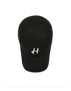 Top down view of black cotton twill baseball cap with white letter H embroidery detail