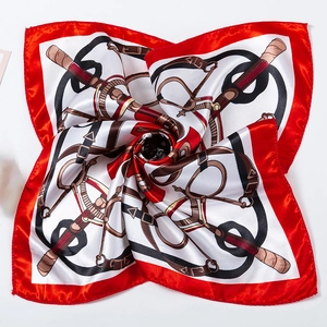 Detail of red and white silk scarf with equestrian horse bit and strap pattern prints