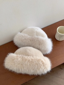 Detailed view of high-density cream faux fur texture on a thick winter bucket hat
