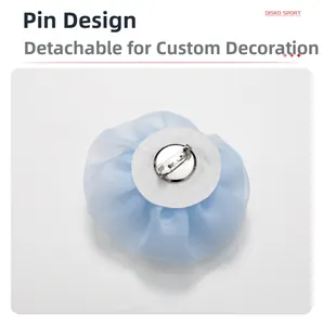Detailed back view showing the silver metal safety pin on the light blue gauze flower
