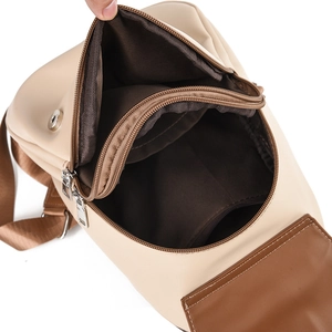 Cream and brown contrast backpack featuring multi-compartment interior for daily commuting