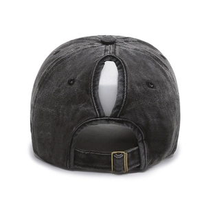 Detail view of washed denim baseball cap with ponytail hole and adjustable metal buckle