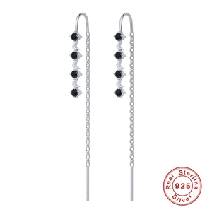 Macro detail of S925 sterling silver tassel earrings featuring black circular gemstones