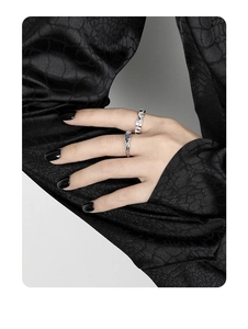 Detailed view of silver liquid lava and woven texture S925 rings on model fingers