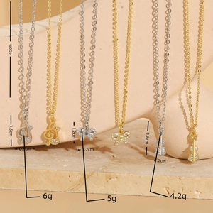 Minimalist gold and silver necklaces with music note, bow, and guitar zircon pendants