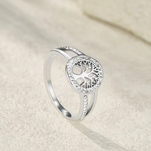 Macro shot of silver Tree of Life ring with sparkling cubic zirconia on stone base