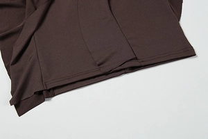 Detailed view of dark brown dress hem featuring professional double needle stitching finish