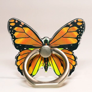 Macro detail of butterfly phone ring holder featuring realistic orange wing patterns