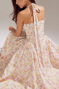 Detail of pink floral halter dress showing open back and delicate white lace crochet trim