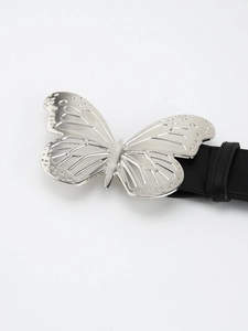 Close-up of metallic silver butterfly buckle with intricate textures on black leather belt