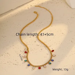 Macro shot of gold stainless steel necklace featuring colorful teardrop crystal pendants