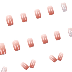 Short square press-on nails featuring peach pink gradient and glitter blue sequins