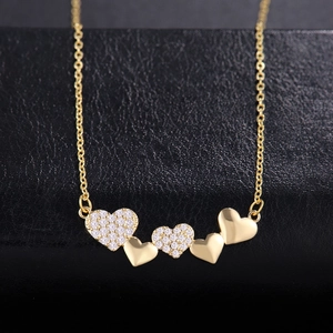 Elegant gold necklace featuring interlocking zircon hearts on a black leather display