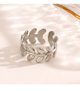 Close-up of adjustable stainless steel leaf ring with polished silver finish and shadows