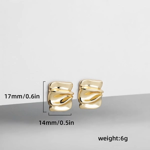 Detail view of 14k gold plated earrings with wavy textured geometric ripple design