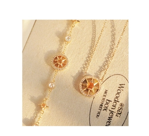 Detailed view of an eight-pointed star compass bracelet with a vibrant yellow zircon stone