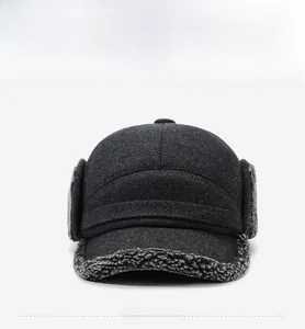 Detail view of winter grey trapper hat featuring warm lamb wool lining and metal sports badge