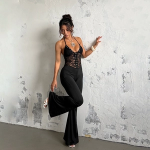 Detail of black lace halter top and high-waisted flare trousers on a model