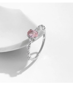 Macro detail of oval pink gemstone ring with s925 silver band and side cubic zirconia