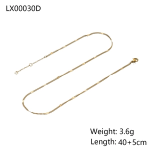 Detailed view of gold snake chain necklace with polished small discs and lobster clasp