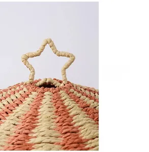 Detail of pink and white woven paper rope basket with a star-shaped handle on top
