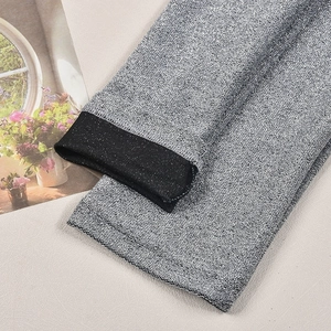 Detail of silver metallic knit fabric with sparkling texture and precision edge stitching