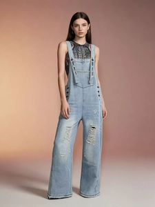 Women's vintage light blue distressed denim overalls with wide leg and ripped details