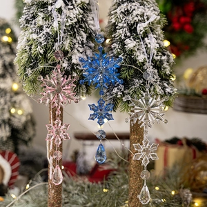Macro shot of colorful acrylic snowflake ornaments with teardrop pendants on Christmas tree