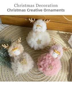 Close-up of three plush Christmas angel elk ornaments with gold heart and star details
