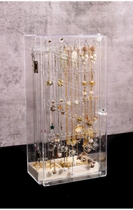 Detail view of transparent acrylic jewelry box with multi-layer hooks and velvet ring tray