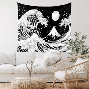 Detail of Great Wave off Kanagawa tapestry hanging above a white sofa in a modern room