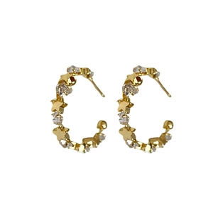 Elegant gold C-shaped hoop earrings featuring sparkling zircons and delicate star patterns
