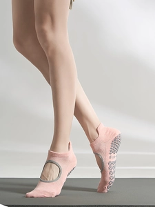 Close-up of pink backless yoga socks with grey anti-slip grip dots on the sole