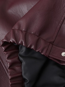 Detailed close-up of dark wine red PU leather jacket with silver metal snap buttons