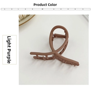 Close-up of matte light purple metal hair claw clip with cross teeth and spring detail